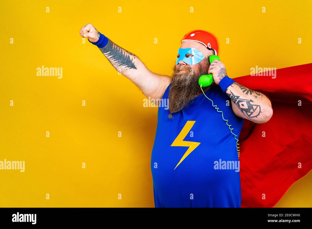 Funny fat man with superhero costume acting as superhuman with special