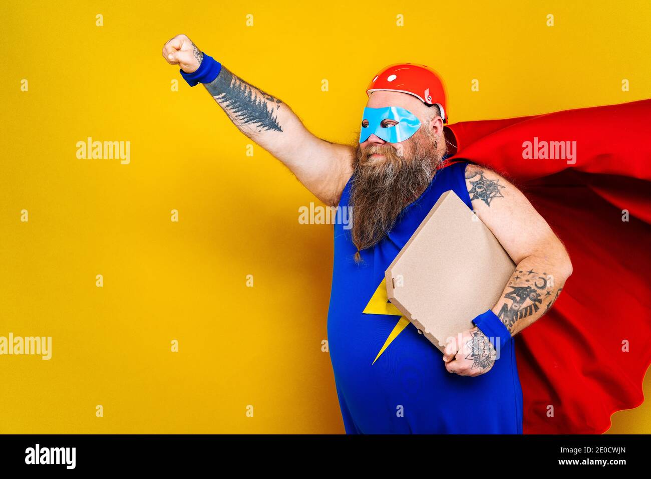 Funny fat man with superhero costume acting as superhuman with special
