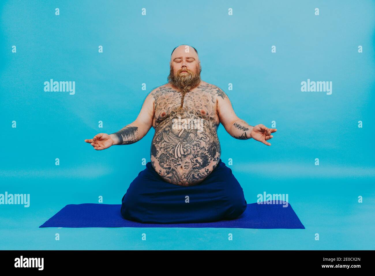 Funny fat man doing yoga meditation, funny and ironic character Stock Photo