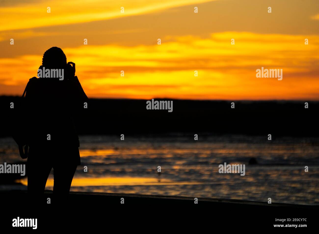 Silhouette of woman watching the sunset hi-res stock photography and ...