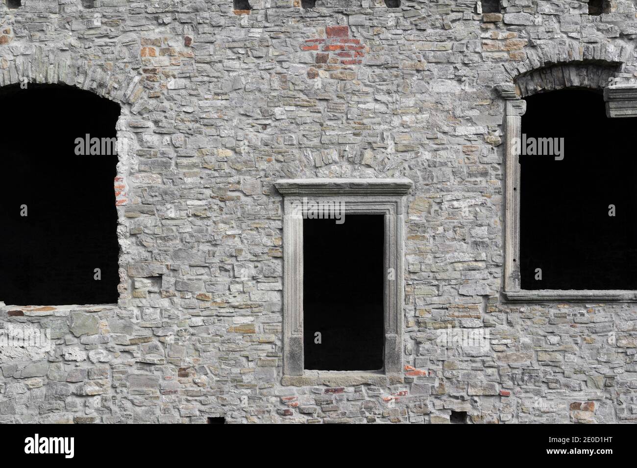 Old, historical and antique wall made of stone. Facade with windows and ...