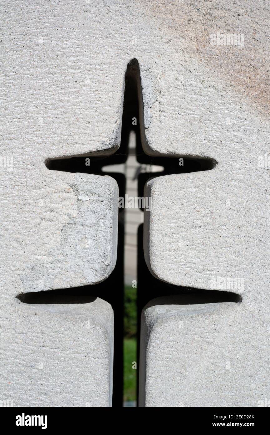 Cross on white wall - hole, aperture, interstice and slit as religious symbol of christianity and christian religion. Stock Photo