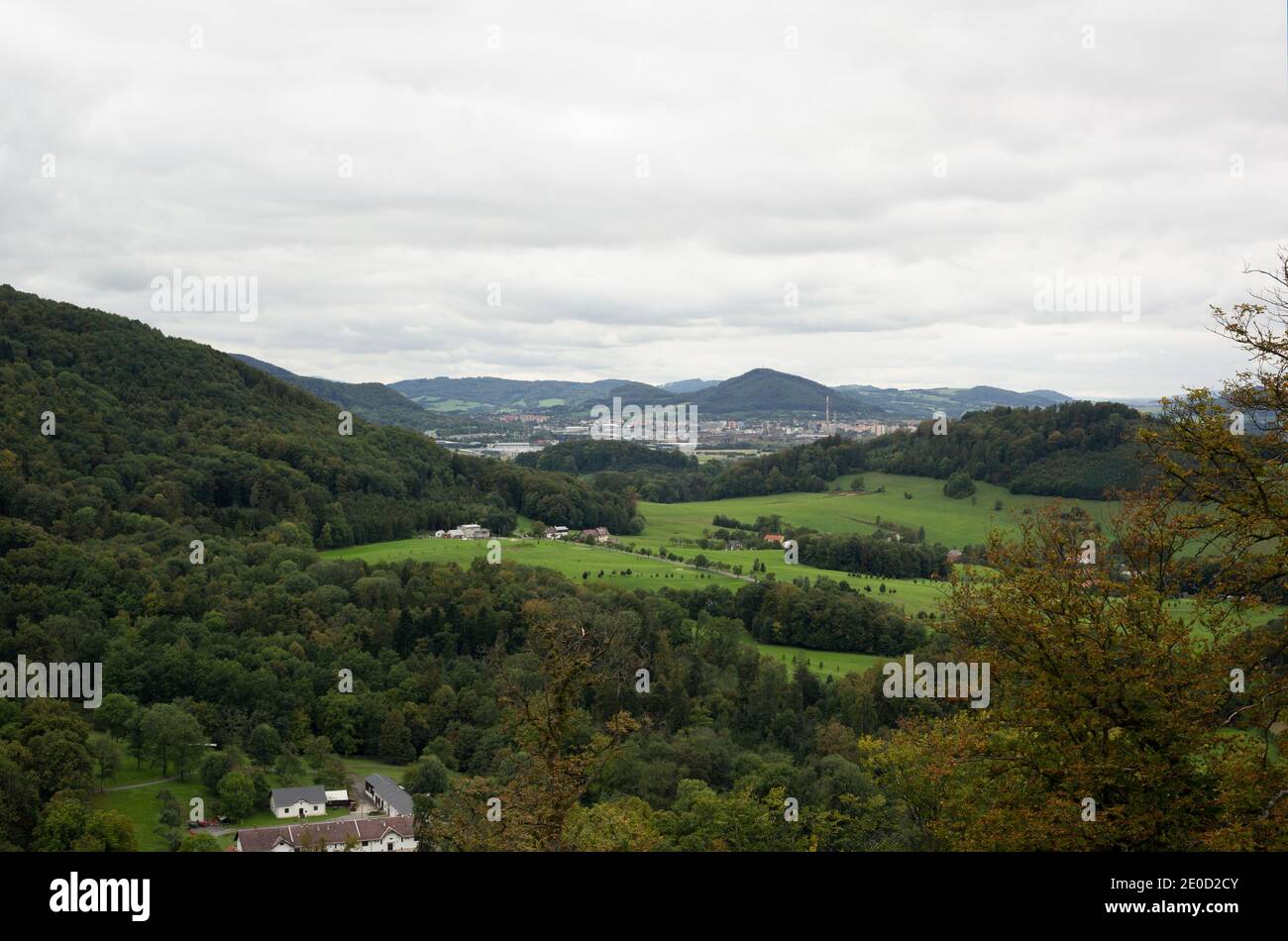 Beskid mountains and Koprivncie town in the valley. Landscape with mountains, hills, meadow, field and town. Cloudy and overcast weather. Stock Photo