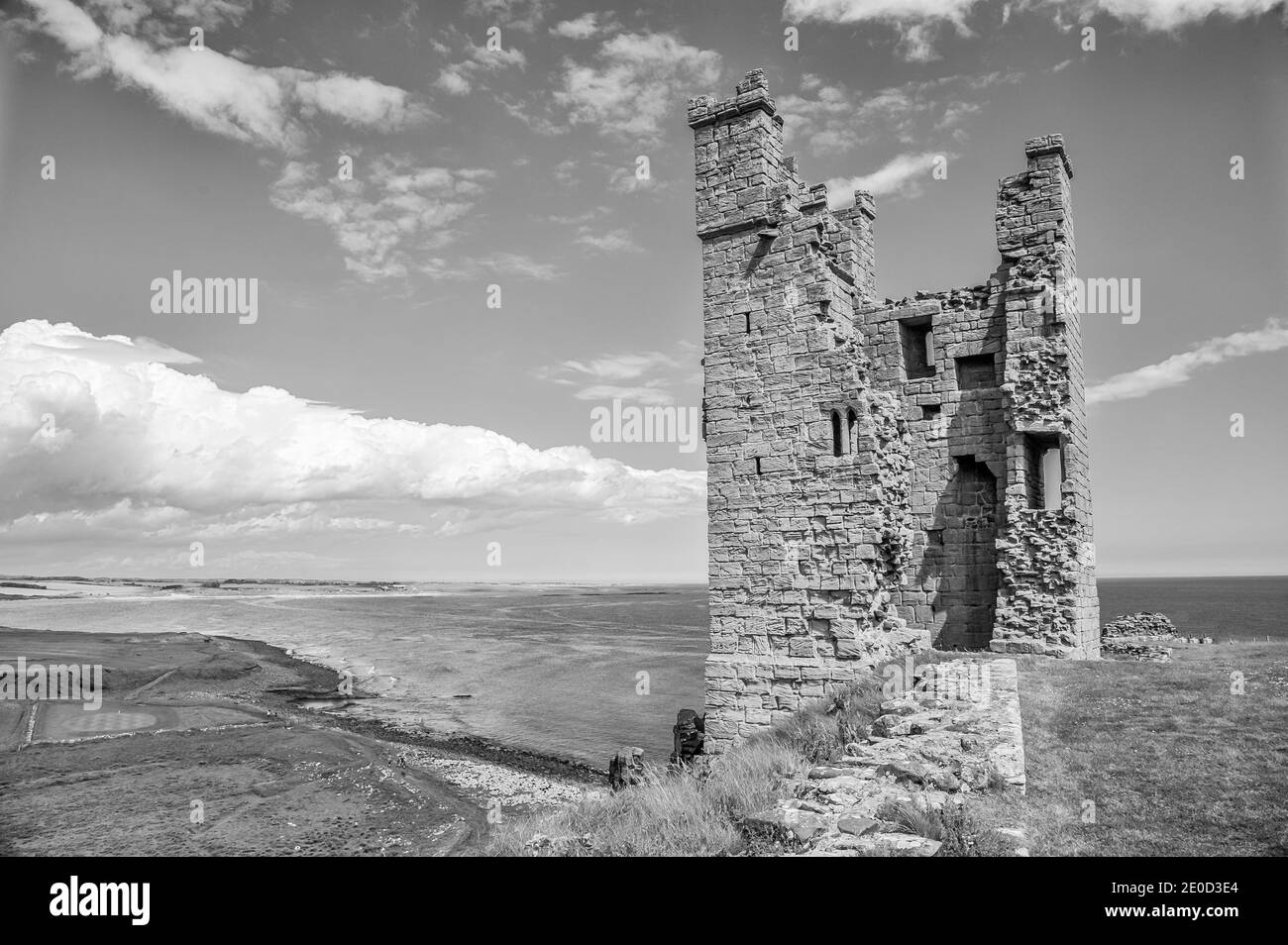 Northumberland. These are the ruins of Dunstanburgh Castle that overlook the sands of Embleton Bay in Northumberland of Northeast England . The castle was  named after the patron Saint of the blind St Dunstan Stock Photo