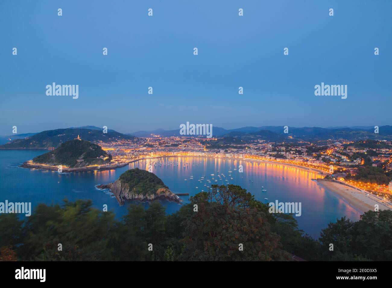 Classic evening view of Ondaretta and La Concha beaches of San Sebastian from high up at the Mirador del Monte Igueldo. Stock Photo