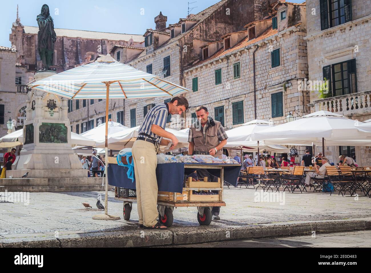 Dubrovnik, Croatia - September 26 2014: Two men share a laugh at Dubrovnik's popular open-air market at Gundulic Square in the heart of the old town. Stock Photo