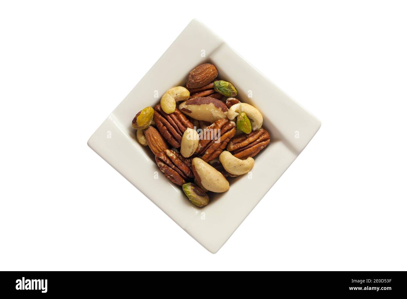 Bowl of natural mixed nuts, cashews, almonds, brazils, pecans and pistachios, unsalted nuts isolated on white background - for Christmas festive Xmas Stock Photo