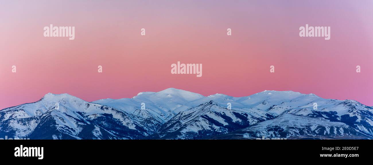 Scene view of snow covered mountains against beautiful pink sunset during winter season in Esquel, Patagonia, Argentina Stock Photo