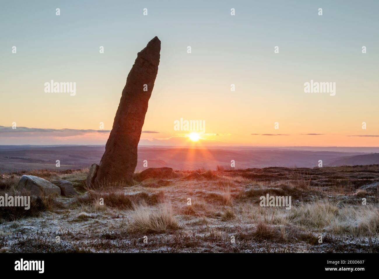 Old boundary stone (early 1700's) on Blakey Rigg looking east at sunrise in the North York Moors national park.   Rough shaped monolithl. The letters Stock Photo