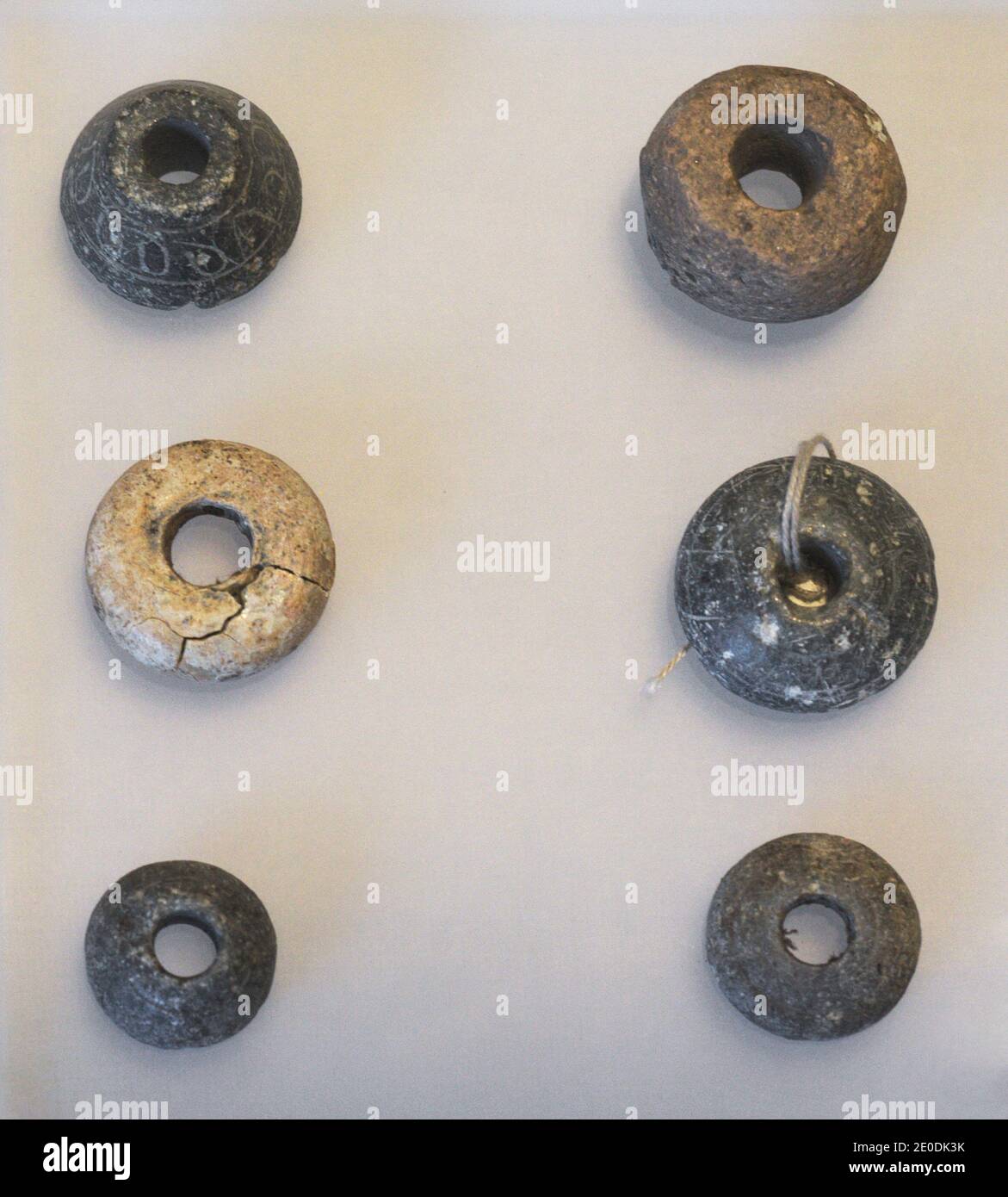 Textile industry. Middle Ages. Decorated spindle whorl. They were placed in the spindle as a counterweight. From the Tower of Hércules (La Coruña, Galicia, Spain. Archaeological and History Museum (San Anton Castle). A Coruña, Galicia, Spain. Stock Photo