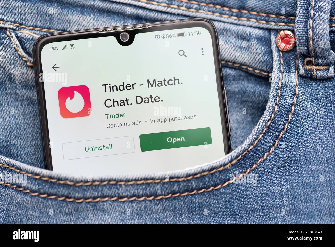 Wroclaw, Poland - NOV 30, 2020: Tinder logo on smartphone in pocket. Tinder is most popular dating app Stock Photo