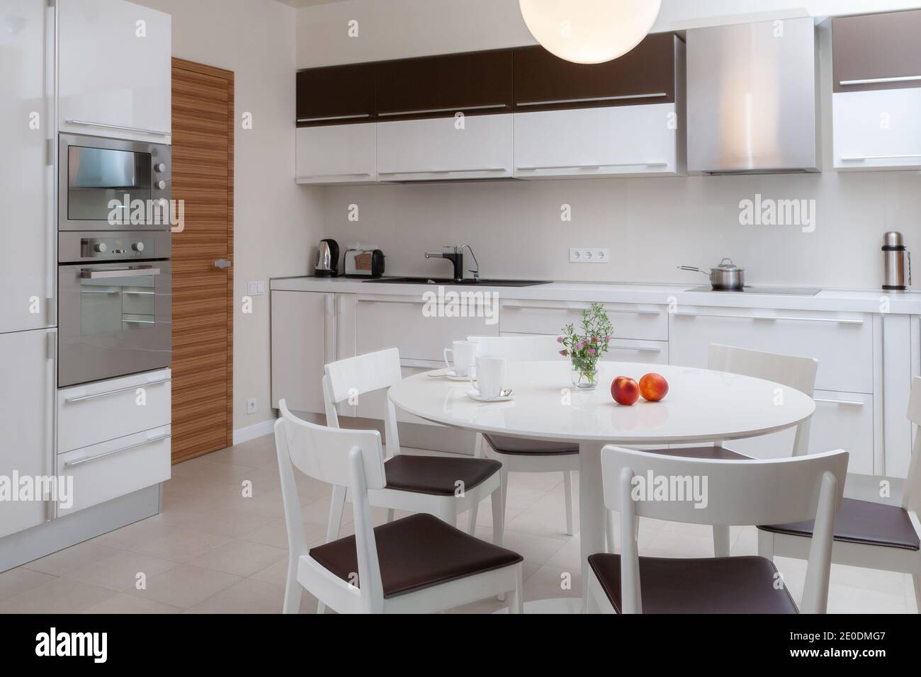 Modern light kitchen interior with white faсade pannels. Kitchen design concept Stock Photo