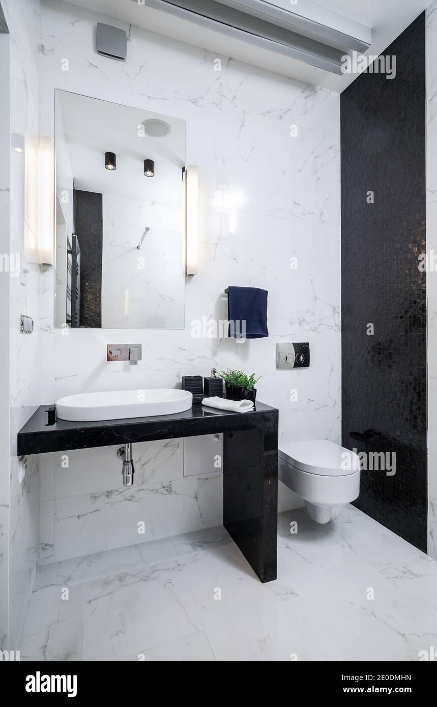 Modern white bathroom interior with marble tiles . Contemporary