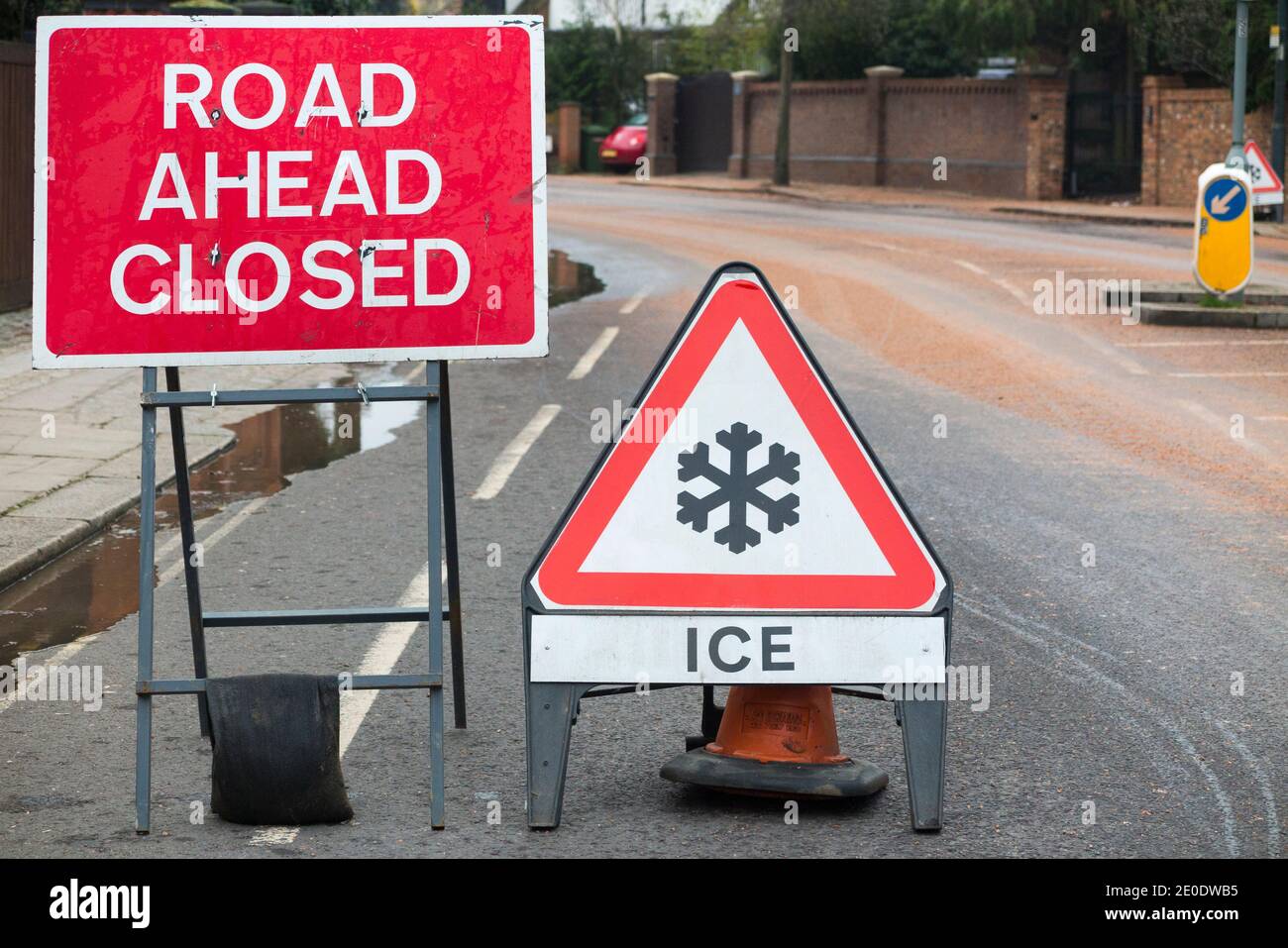 Road ahead closed, snowflake sign, & rock salt fresh grit / freshly spread precautionary salting