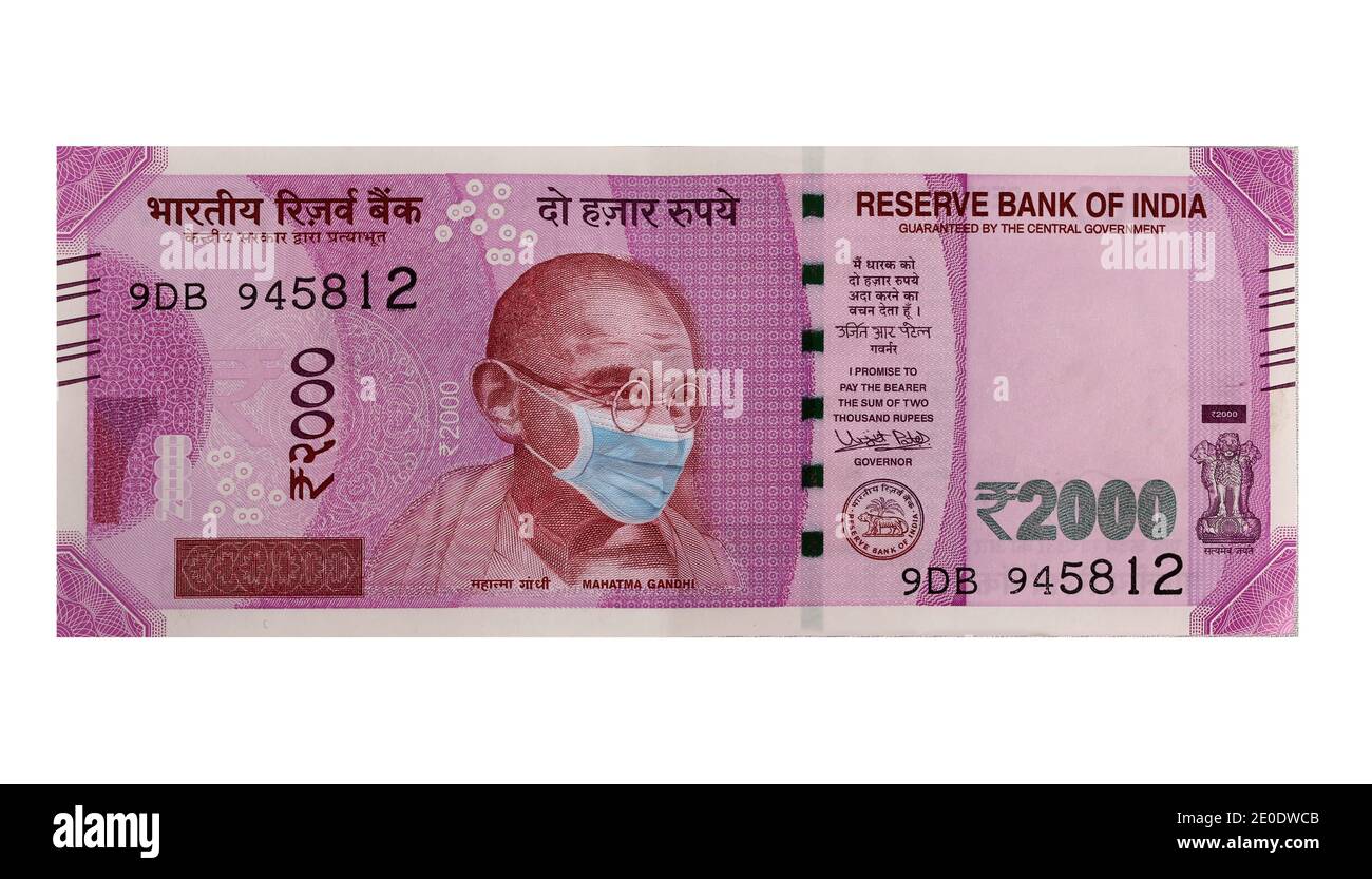 COVID-19 coronavirus in India. Two Thousand Indian Rupee, Rs. 2020 banknote with Mahatma Gandhi with Covid-19 mask. Stock Photo