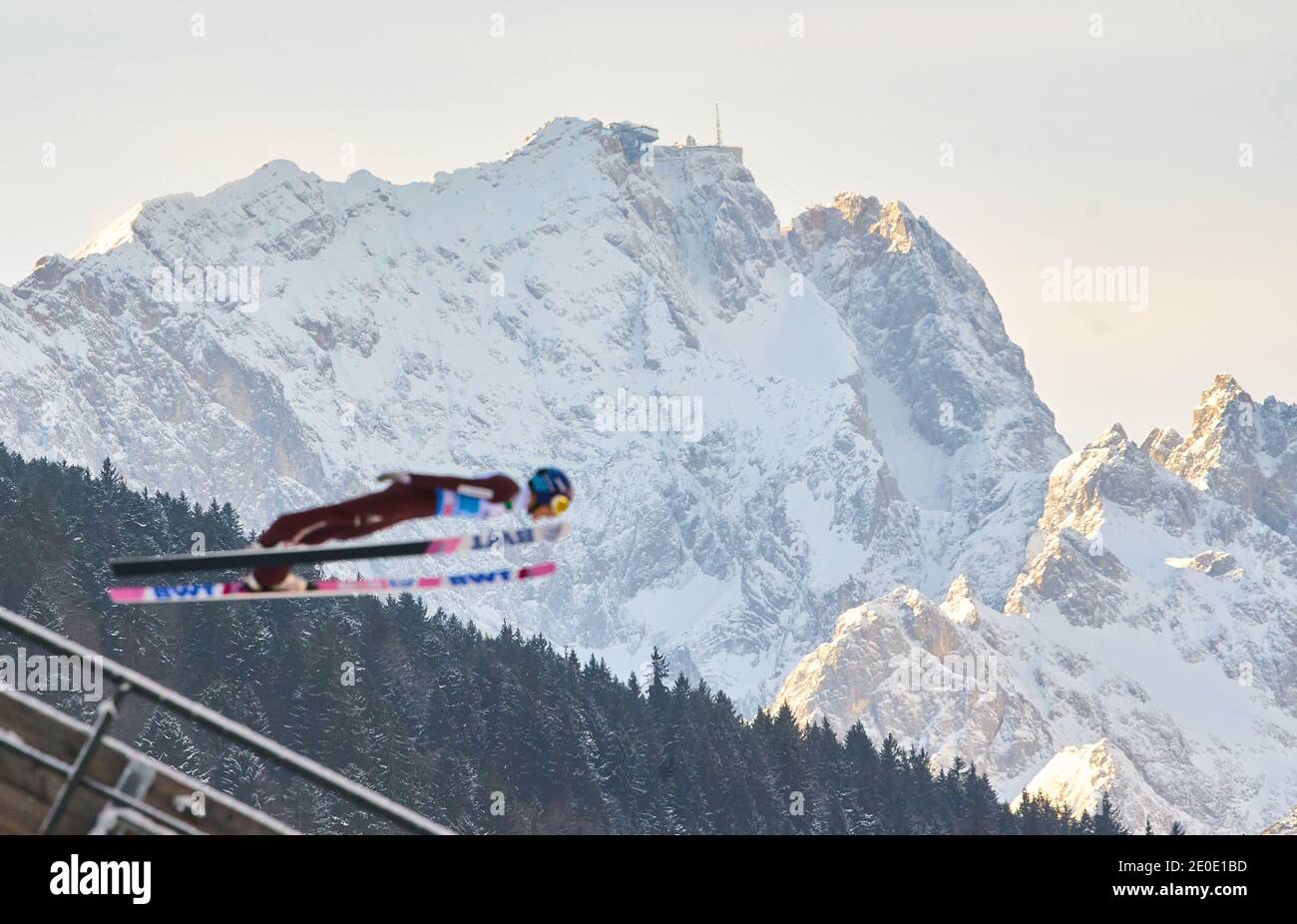 Ski jumper in front of Zugspitze mountain at the Four Hills Tournament Ski Jumping at Olympic Stadium, Grosse Olympiaschanze in Garmisch-Partenkirchen, Bavaria, Germany, December 31, 2020.  © Peter Schatz / Alamy Live News Stock Photo