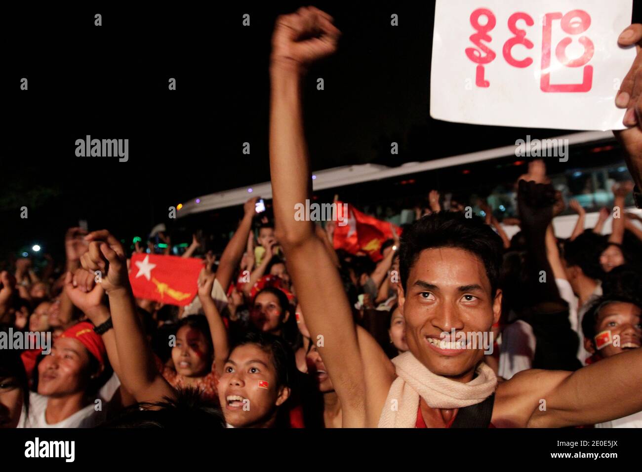 National League for Democracy (NLD) supporters celebrate their victory in the parliamentary elections outside the party headquarters in Yangon, Myanmar on April 1, 2012. Thousands of people of an extraordinary variety of races, ages and social background watched together the results on a wide screen with the loud sound of Rapp and Hip Hop songs to celebrate for the first time a democratic election. Photo by Minzayar/Jazz Editions/ABACAPRESS.COM Stock Photo