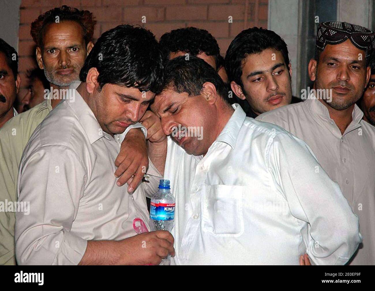 Men at PIMS Hospital, weep on the death of their relatives who were killed in a plane of Boja Air which was crashed when it was about to land in Benazir Bhutto International Airport as it was coming from Karachi with more than 120 people on board during rain on Friday. Photo by Irfan Ali/ABACAPRESS.COM Stock Photo