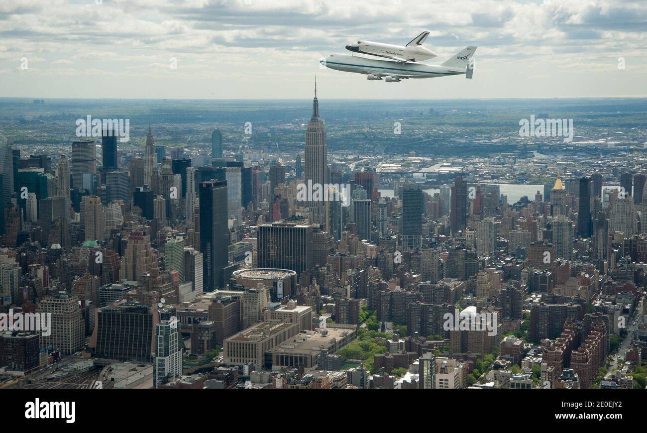 Space shuttle Enterprise, mounted atop a NASA 747 Shuttle Carrier Aircraft (SCA), is seen as it flies near the Empire State Building, Friday, April 27, 2012, in New York. Enterprise was the first shuttle orbiter built for NASA performing test flights in the atmosphere and was incapable of spaceflight. Originally housed at the Smithsonian's Steven F. Udvar-Hazy Center, Enterprise will be demated from the SCA and placed on a barge that will eventually be moved by tugboat up the Hudson River to the Intrepid Sea, Air & Space Museum in June. Photo by Robert Markowitz/Nasa via ABACAPRESS.COM Stock Photo