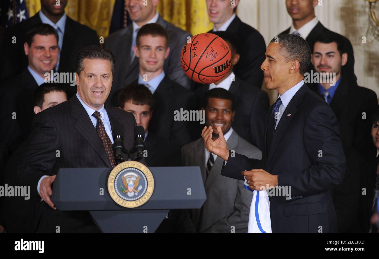 US President Barack Obama plays with a basketball as Coach John Calipari looks on during a celebration of the University of Kentucky men's basketball team for their 2012 NCAA championship in the East Room of the White House in Washington, DC, on May 4, 2012. Photo by Olivier Douliery/ABACAPRESS.COM Stock Photo