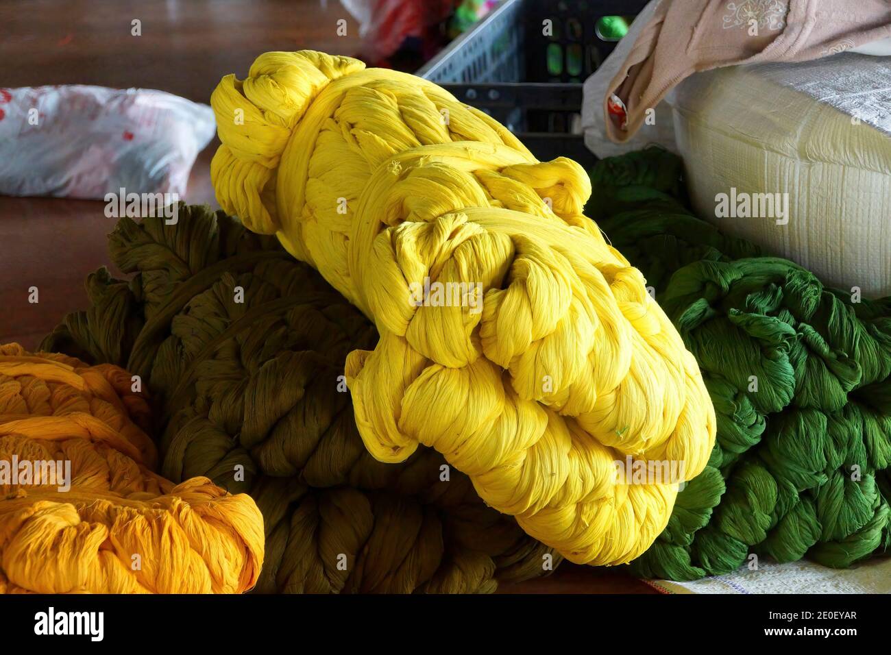 Bright yellow skeins of silk, ready for weaving, Inn Paw Khan village, Inle Lake Myanmar (Burma) Stock Photo