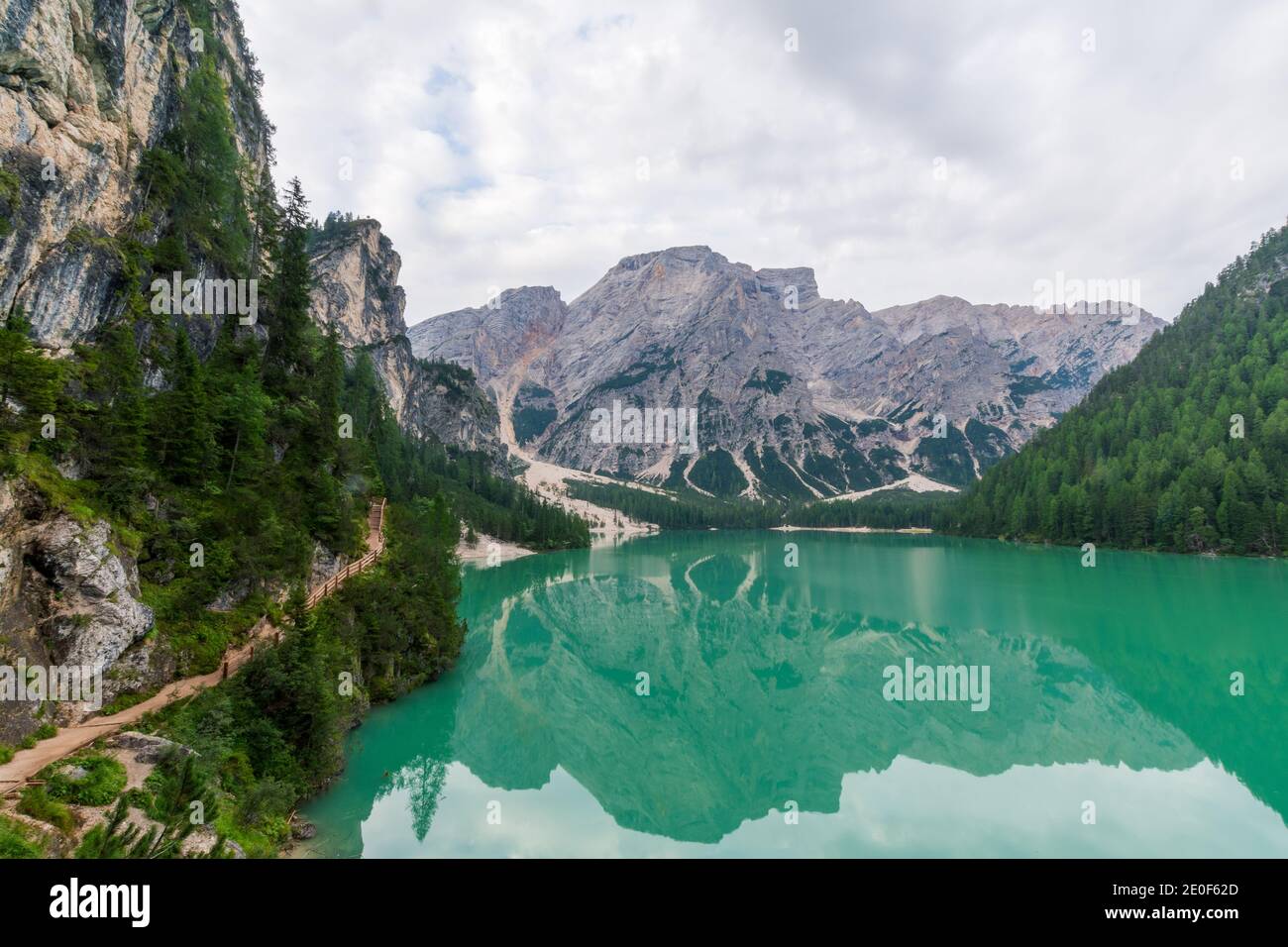 View of Lake Braies and a path that runs alongside it, in the background the Seekofel or Croda del Becco Stock Photo