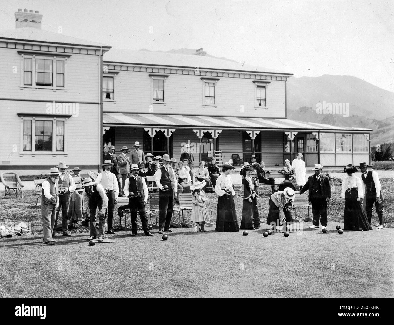 People play bowls at the lodge, Hanmer Springs health resort, Canterbury, New Zealand. Image circa 1916, from the Logie family collection. Stock Photo