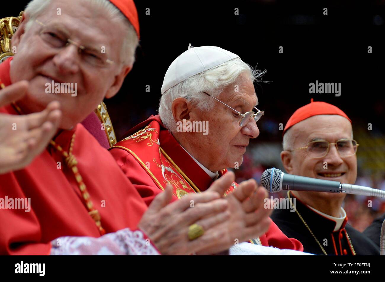 Pope Benedict XVI (c), cardinal Angelo Scola (L) Archbishop of Milan and Vatican Secretary of Sate Tercisio Bertone (r) attend a celebration with candidates for Confirmation at San Siro stadium in Milan, Italy on June 2, 2012 as part of the 7th World Meeting of Families . During this three-day trip in Milan pope Benedict XVI praised the family as 'the principal heritage of humankind'. It is the first time in 28 years that a pope has been to Milan, Italy's economic capital and Europe's biggest diocese with five million inhabitants. Photo by ABACAPRESS.COM Stock Photo