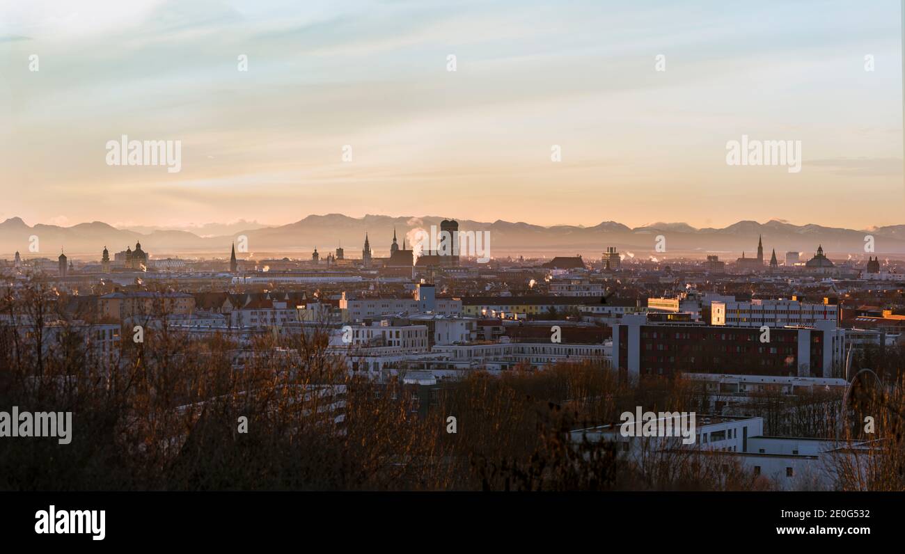 Clean and complete Munich skyline at winter sunrise - with Alps visible in background Stock Photo