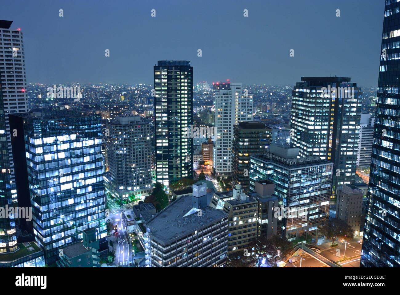 The futuristic Shinjuku-ku district at night, Tokyo JP Stock Photo