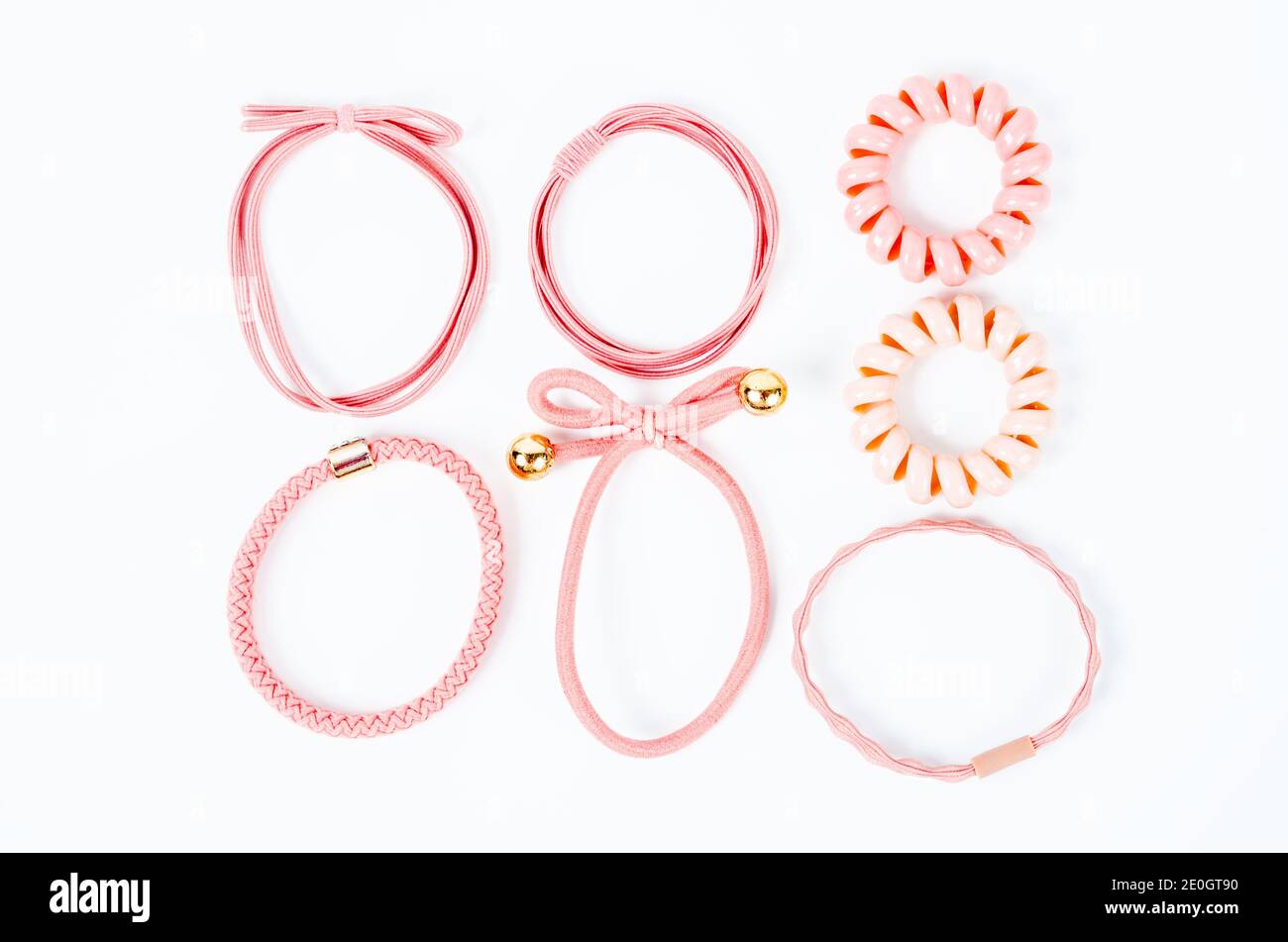 Set of pink fabric rubber bands. Elastic hair ties in vibrant colors on white background. Stock Photo