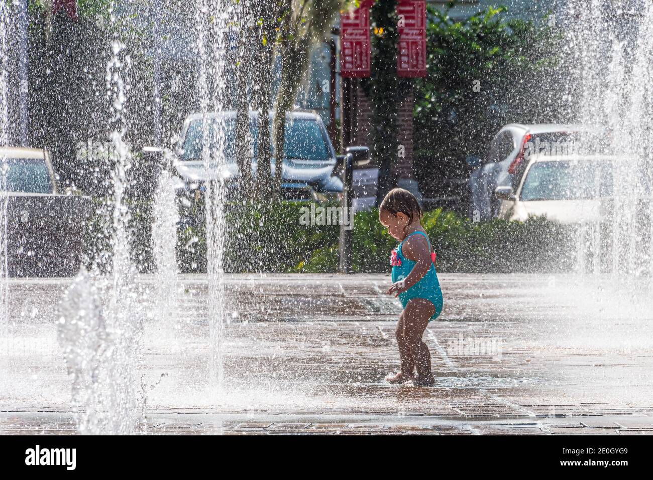 Toddler enjoying the Winter Garden Interactive Fountain & Splashpad in Downtown Winter Garden, Florida. (USA) Stock Photo