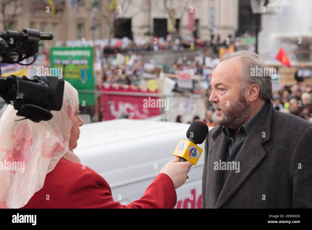 George Galloway being interviewed at an anti war rally Trafalgar Square the culmination of a  march which started at Marble Arch. The protest was  for the removal troops from Iraq and nuclear disarmament. Trafalgar Square, London, UK.  24 Feb 2007 Stock Photo