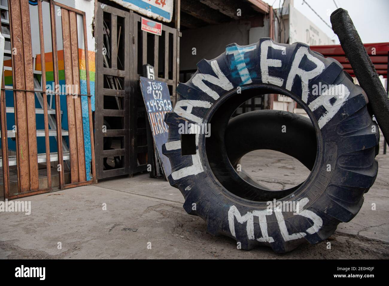 A large tire on the sidewalk advertises a tire shop in San Carlos, Sonora, Mexico. Stock Photo
