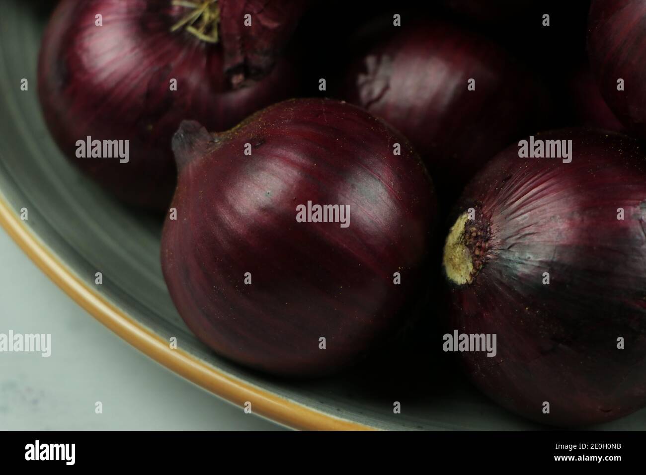 sweet red onions on background Stock Photo