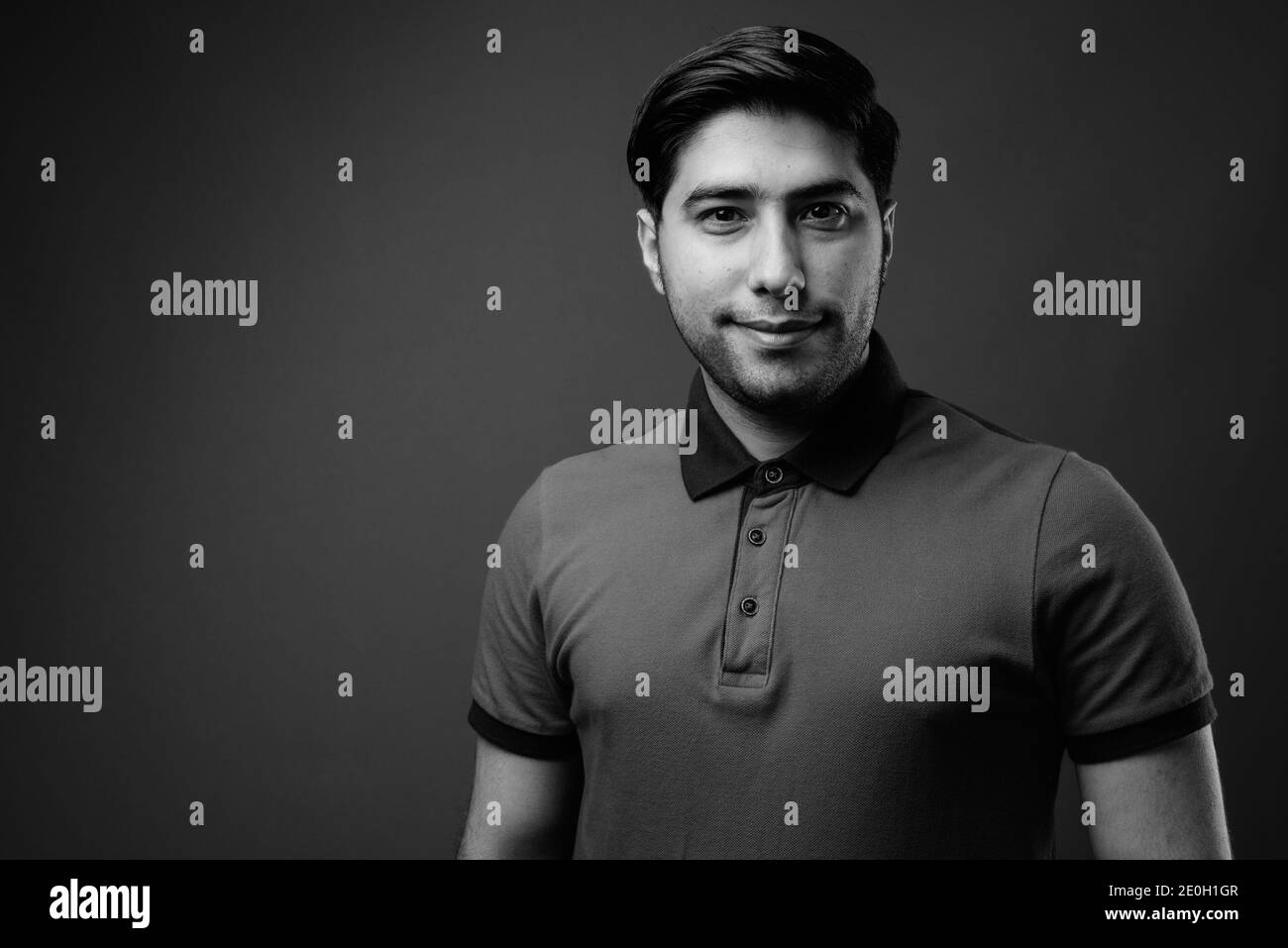 Studio shot of young handsome Iranian man shot in black and white Stock Photo