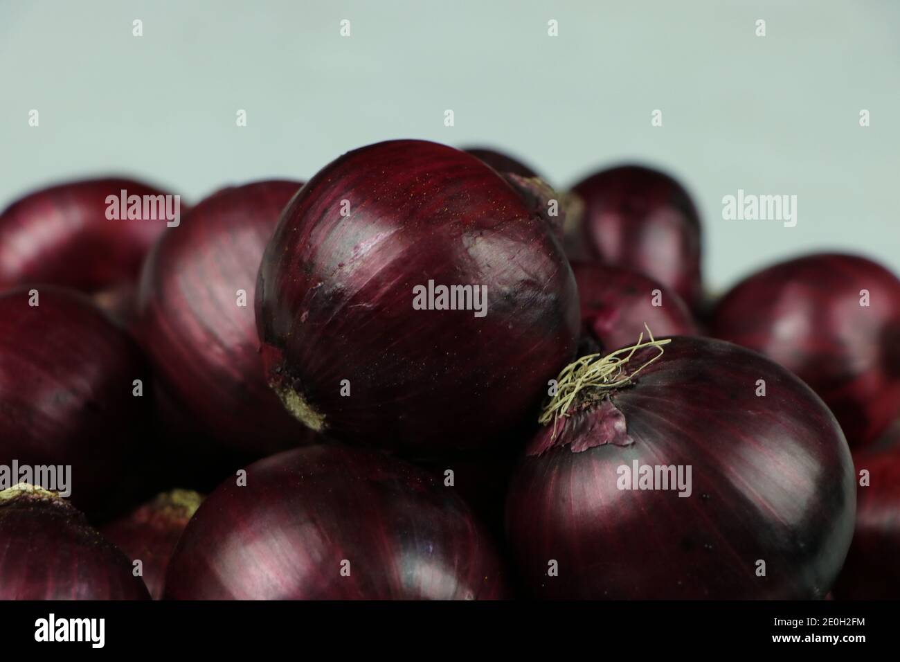 sweet red onions on background Stock Photo
