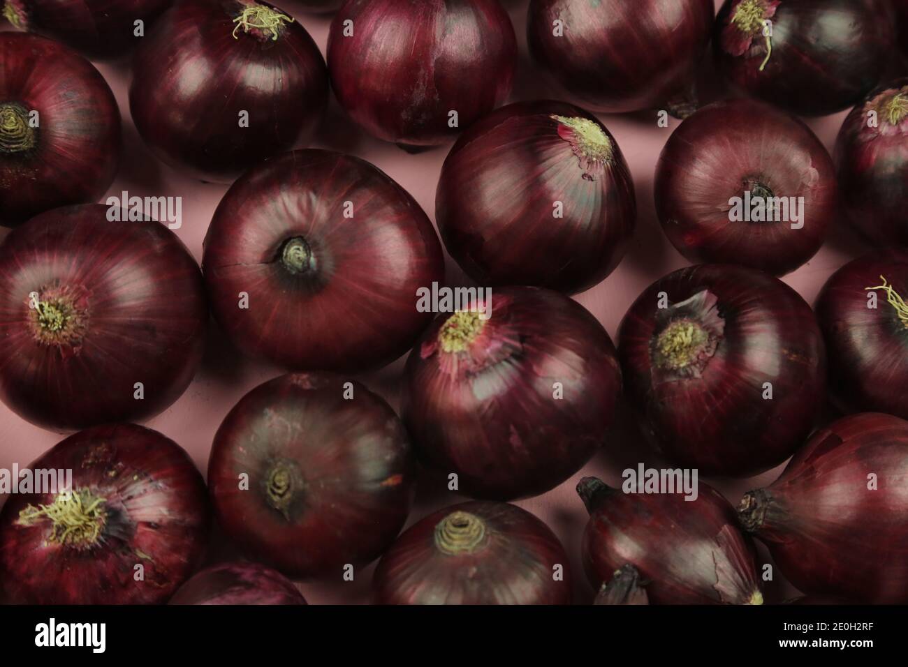 sweet red onions on background Stock Photo