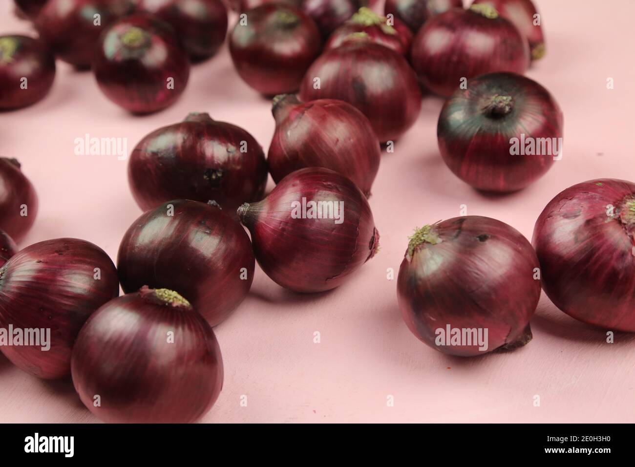 sweet red onions on background Stock Photo