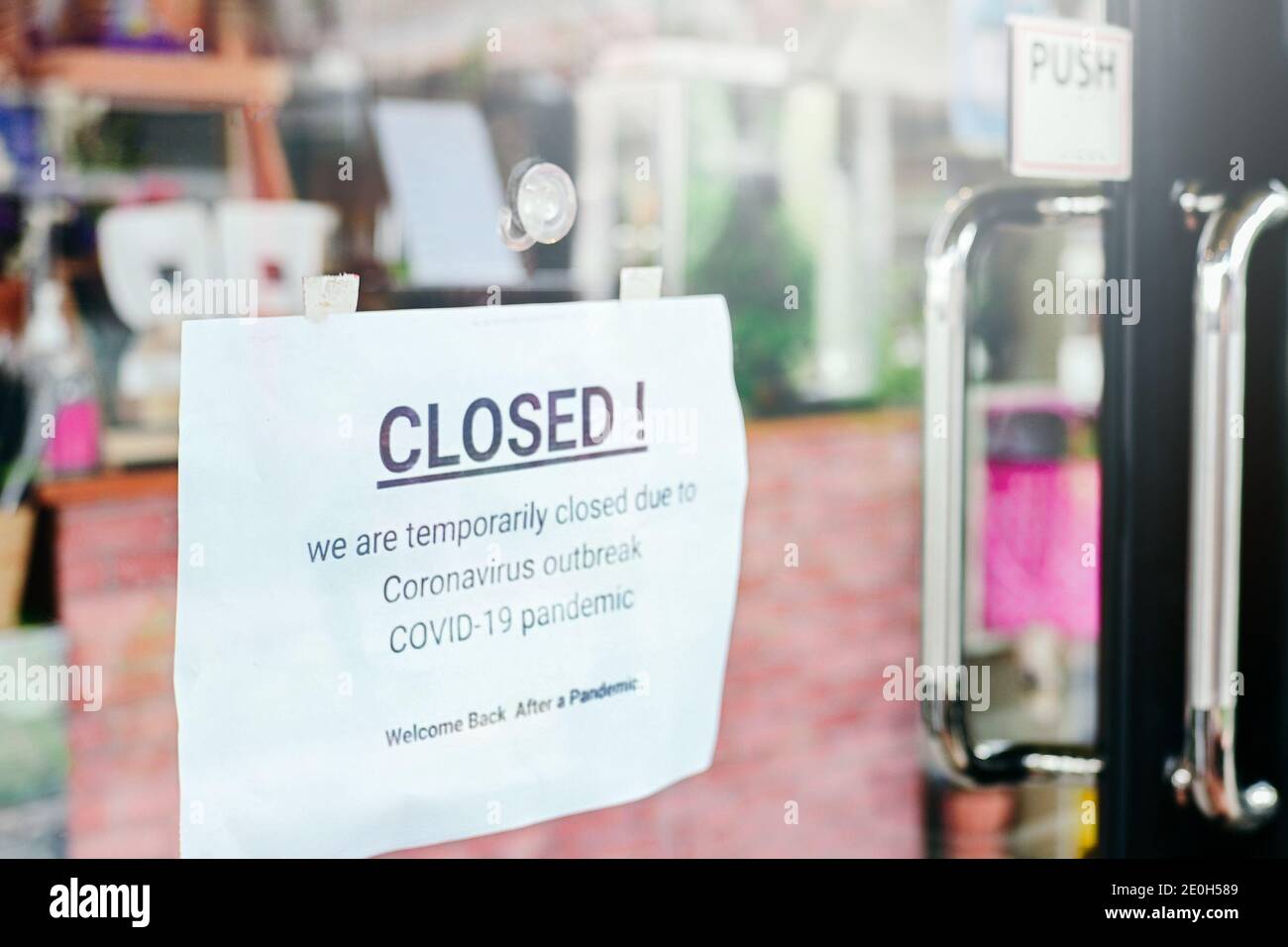 Closed notice on door entrance cafe restaurant or business office store