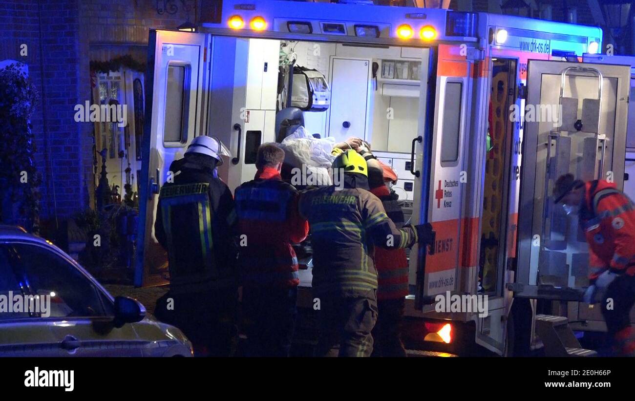 Hilter, Germany. 01st Jan, 2021. Rescue workers attend to an injured man. Three men were injured in an explosion on New Year's Eve in a residential building near Osnabrück - one of them is in danger of dying. According to police, the 20, 21 and 26 year old men had been handling chemicals to make a firecracker. The explosion occurred on the upper floor of a semi-detached house. Credit: -/ TV7News /dpa/Alamy Live News Stock Photo