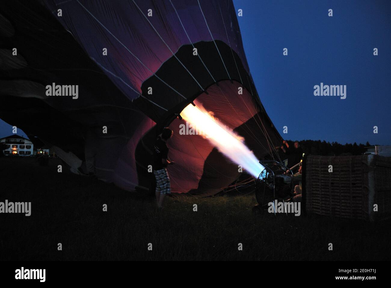 purple balloon inflation with bright hot fire in the night Stock Photo
