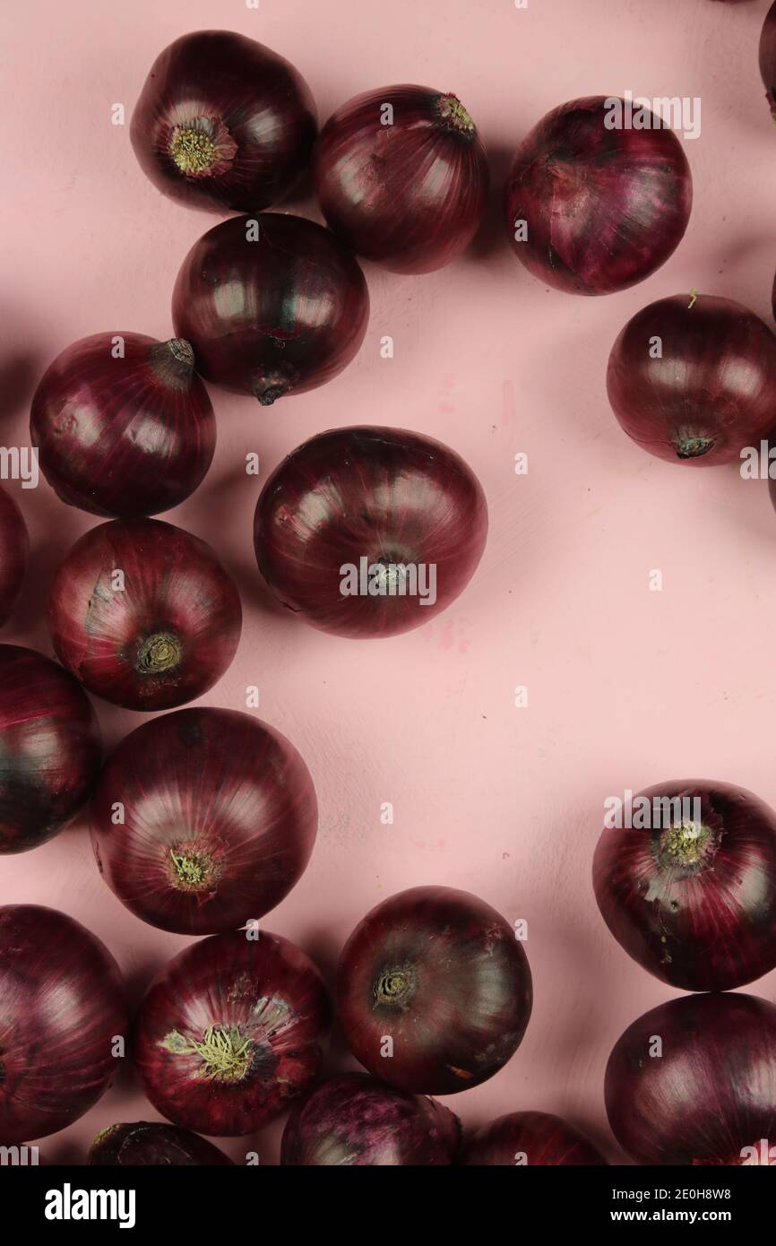 sweet red onions on background Stock Photo