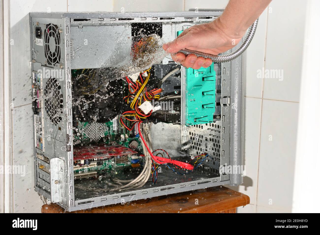 Computer Getting Sprayed With A Hose Insane water cleaning of inside computer for fresh start Stock Photo ...