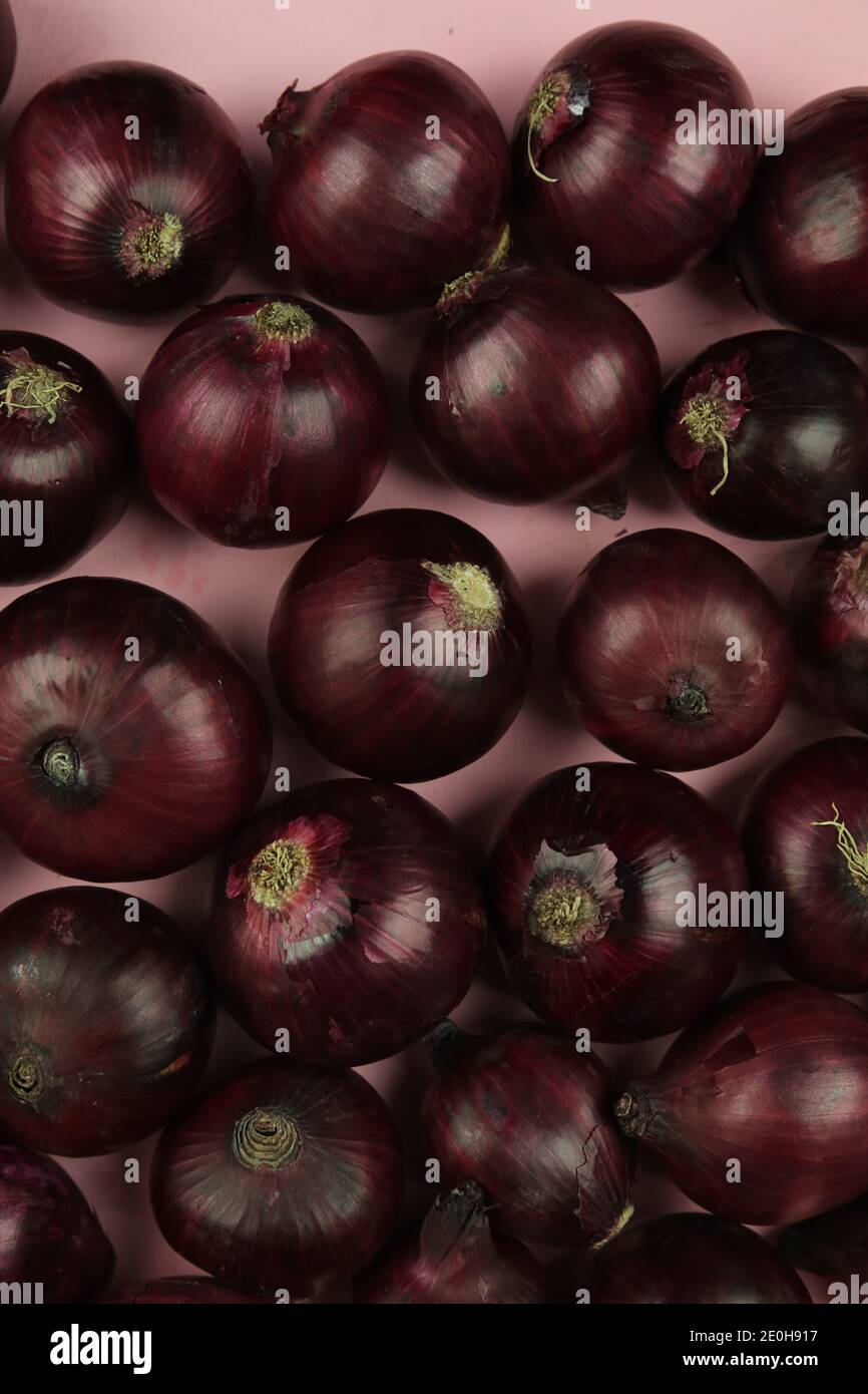 sweet red onions on background Stock Photo