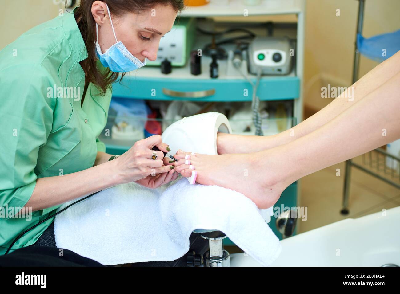 Woman getting a pedicure and relaxing at the beauty salon. Professional