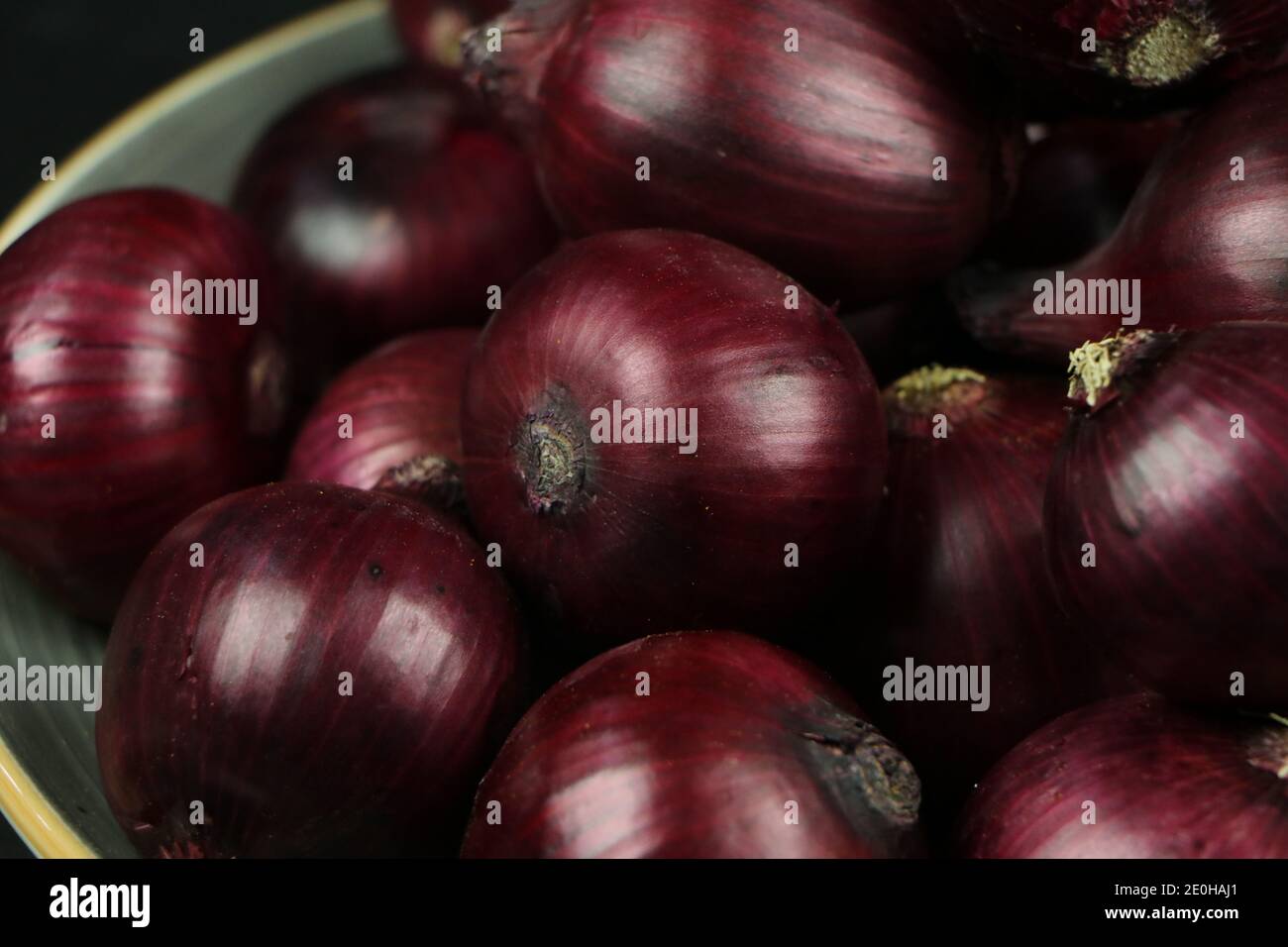 sweet red onions on background Stock Photo