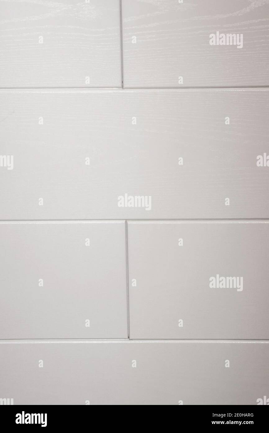White tiles and gray joints on the wall Stock Photo