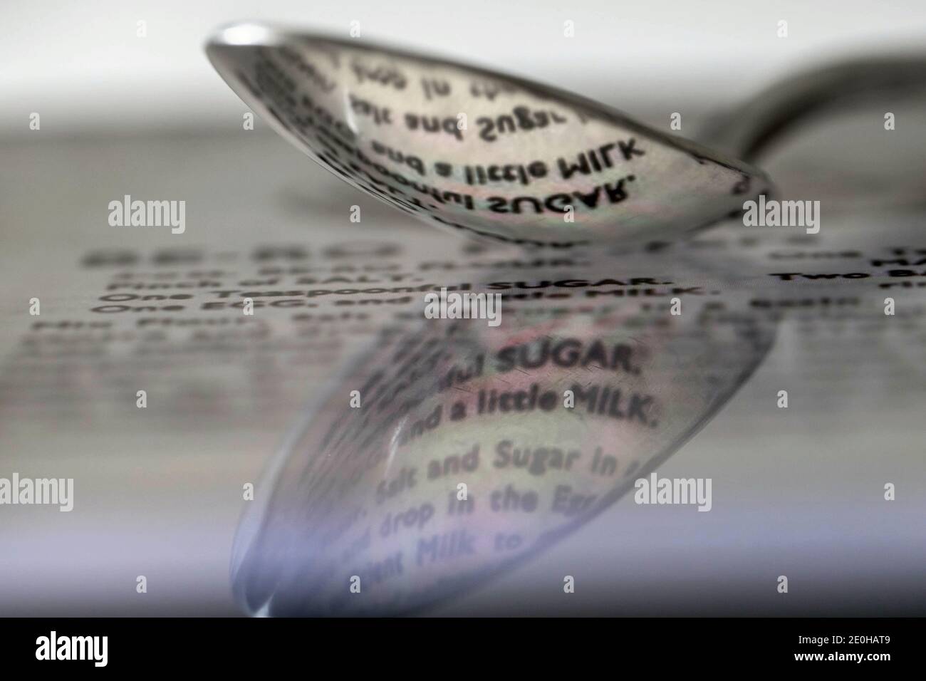 spoon reflecting words from a recipe Stock Photo