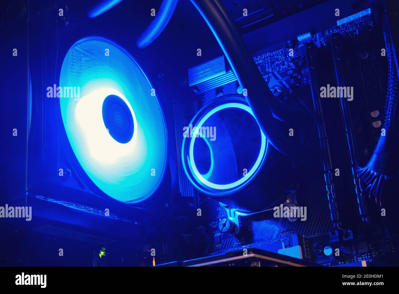 Open computer system unit with blue neon light water cooling Stock Photo